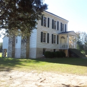 View of house with 2 stone chimneys